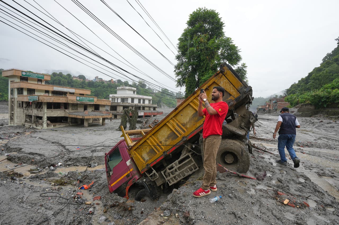 Un visitante de Katmandú graba con su teléfono móvil un vídeo de la destrucción causada por las inundaciones repentinas en el distrito de Nuwakot, Nepal, el sábado 29 de agosto de 2026.