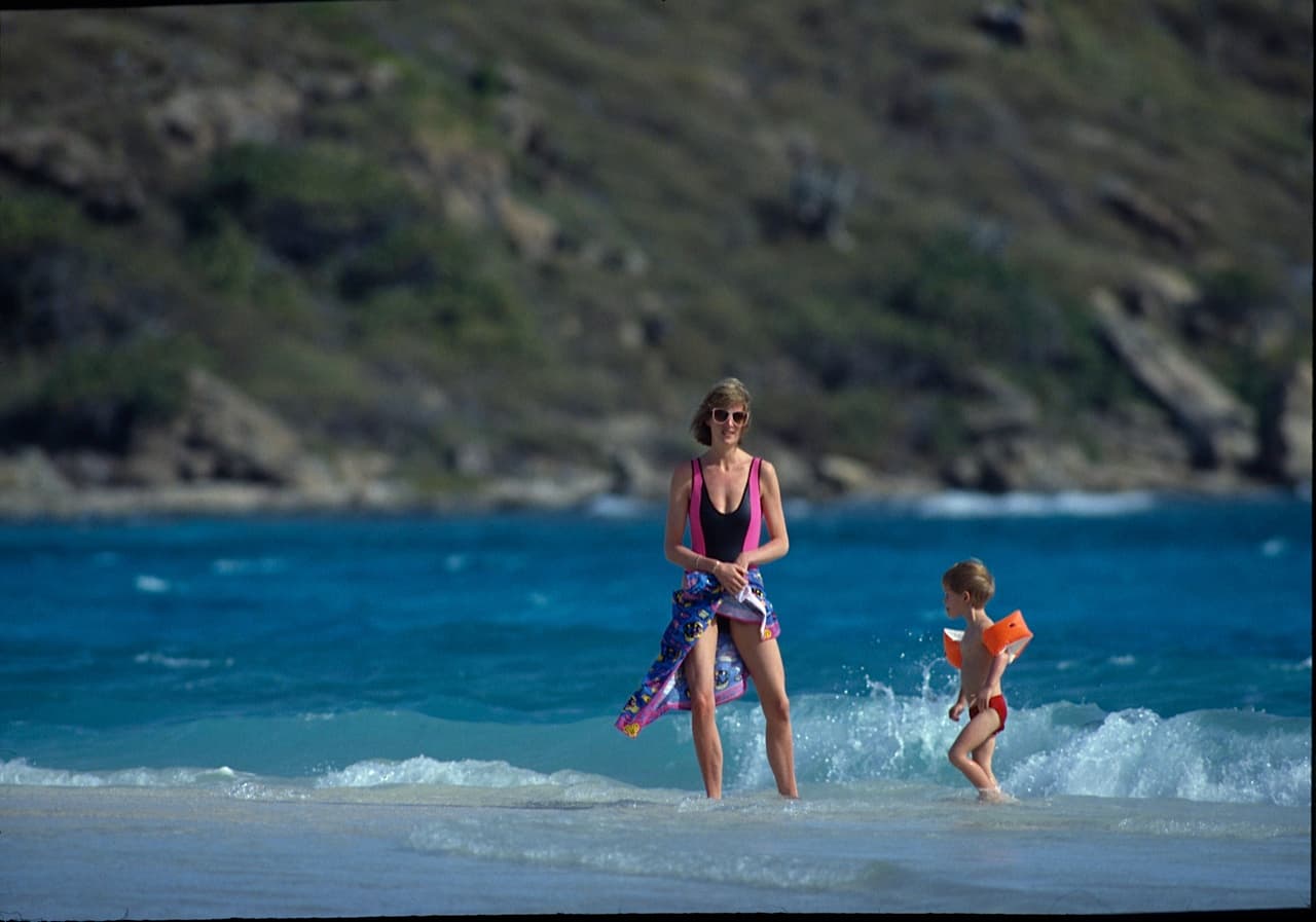 <b>La icónica princesa Diana (Lady Di) </b>en la isla de Necker, propiedad de Richard Branson, (Islas Vírgenes Británicas). Diana de Gales está junto a su hijo menor, el príncipe Harry de Inglaterra, ahora duque de Sussex. Fue a tomarle fotos allí en dos ocasiones, esta vez fue en 1991. Había un acuerdo con sus guardias de seguridad, la dejaban unos cuatro días que tomara sol en paz y luego se acercaban en botes y le toman fotos por media hora. Esta foto está montada en una de las paredes de la oficina de Raúl de Molina en Univision, en Doral, Florida.