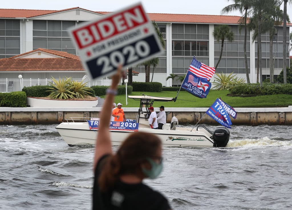 <b>Ese dato fue luego rectificado por la Casa Blanca lo que enseguida generó dudas sobre si el presidente pudo haber sido diagnosticado antes de que él mismo diera la noticia de su contagio en Twitter, la madrugada del jueves. </b>En la foto, una mujer sostiene un cartel del candidato presidencial demócrata Joe Biden frente al paso de los seguidores de Trump en un bote,
<br>
<br>