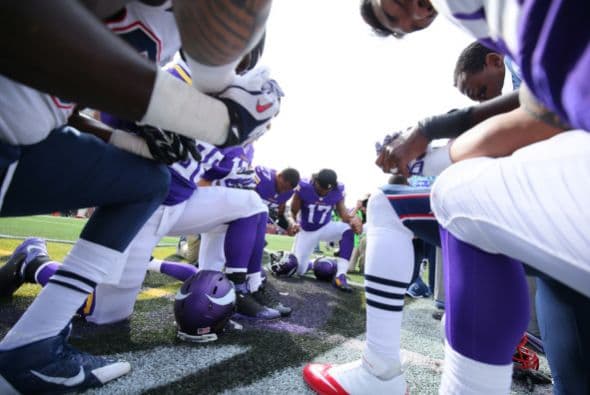 Jugadores de los Minnesota Vikings y los New England Patriots rezan después del partido en el TCF Bank Stadium, realizado el 14 de septiembre de 2014 en Minneapolis, Minnesota.