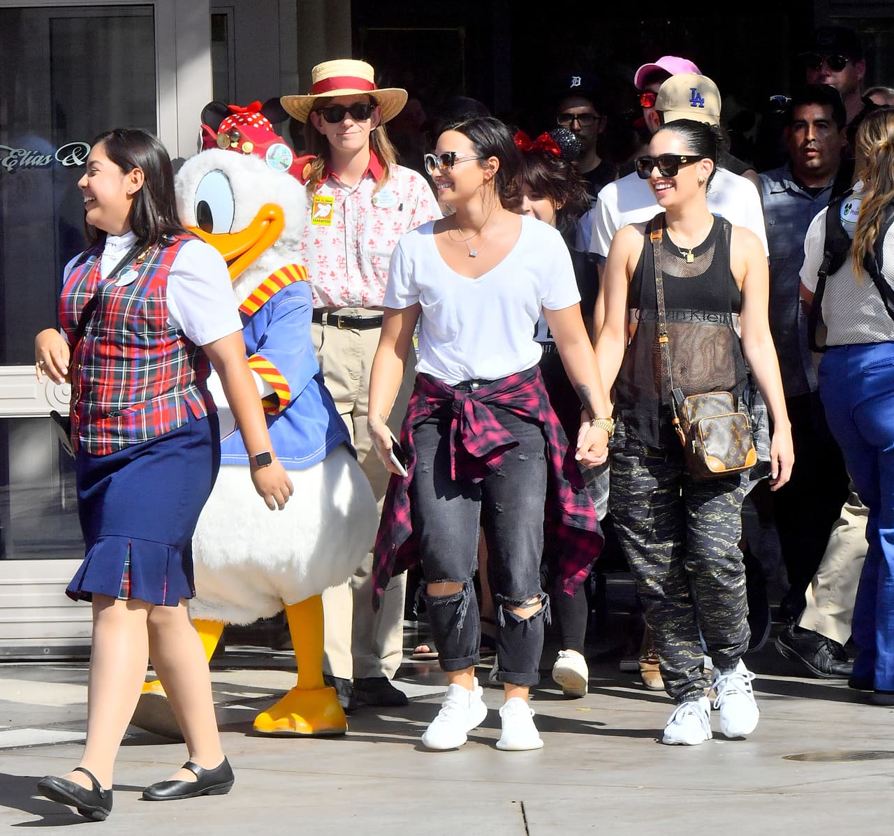 Photo © 2017 Mega/The Grosby Group EXCLUSIVE Los Angeles, CA September 11, 2017 Demi Lovato holds hands with a mystery woman while spending a happy day a Disneyland gets photobombed by Donald Duck. Demi and her new lady walked hand in hand all day Long as they enjoyed a day. they were seen riding the California screaming rollercoaster. Demi looked extremely happy.