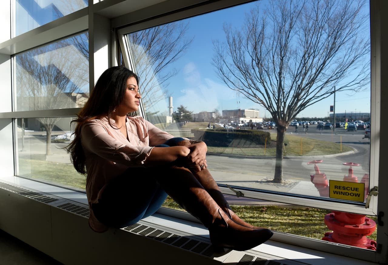 In this Feb. 2, 2016 photo, Naila Amin, 26, looks out from a classroom window at Nassau Community College where she is a student in Garden City, N.Y. Amin, who was forced into marriage at the age of 15 to a 28-year-old cousin in Pakistan who beat and mistreated her, aspires to become a social worker and open a group home for girls trying to avoid or recover from forced marriages. (AP Photo/Kathy Kmonicek)