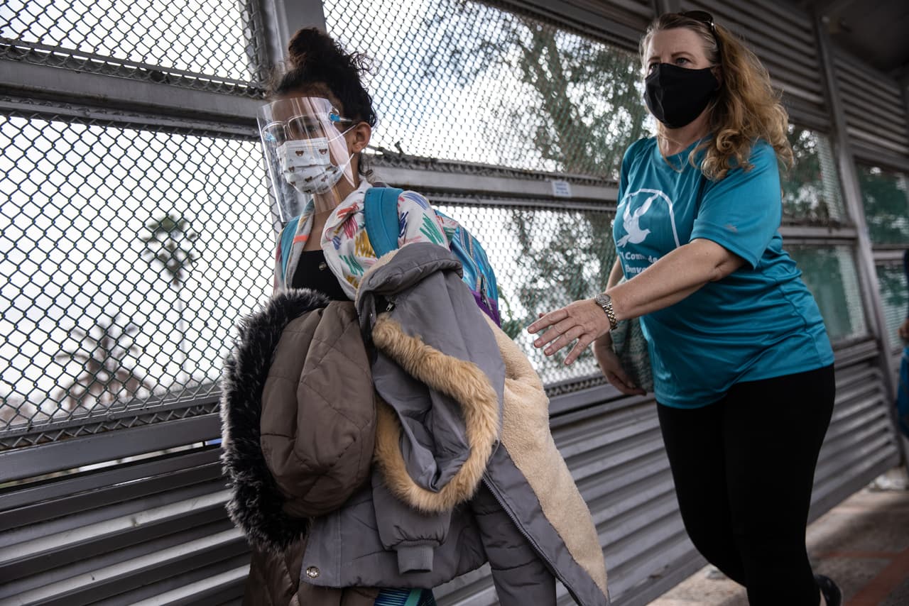 <b>Le echa una mano.</b> Una voluntaria ayuda a un inmigrante a cruzar la frontera entre Estados Unidos y México.