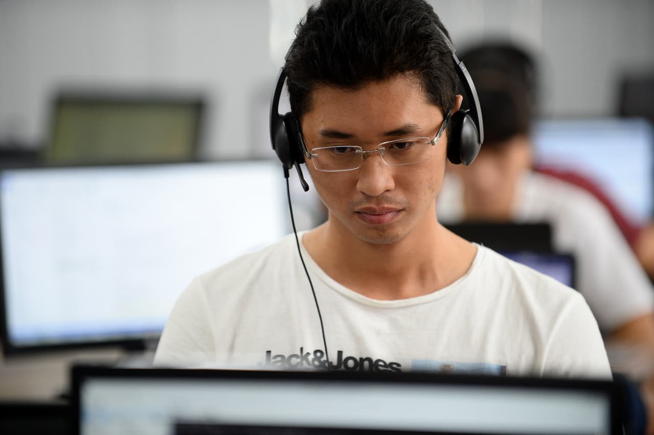 This picture taken on September 5, 2016 shows an employee working inside the French IT company Linkbynet in Ho Chi Minh City. A decade ago app technology would likely have been developed in California's Silicon Valley, but today those apps are being churned out by Vietnam's startup sector -- an industry driven by local techies trained overseas but returning home to prowl for opportunities. / AFP / STR / TO GO WITH Vietnam-technology-economy-startups,FOCUS by Hervé ASQUIN, with Jenny VAUGHAN in Hanoi (Photo credit should read STR/AFP/Getty Images)