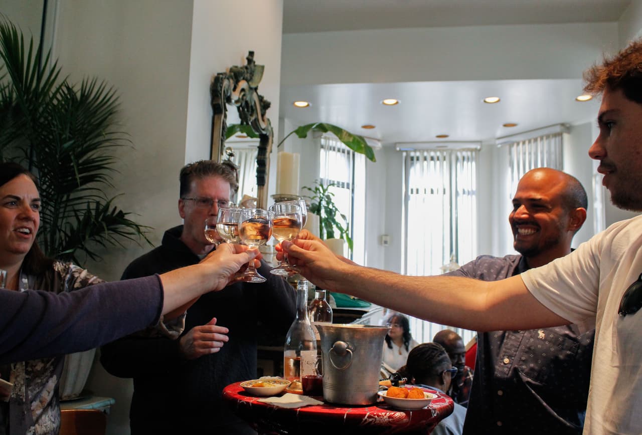 Un grupo de amigos brinda con copas de vino disfrutando del acogedor comedor interior del restaurante.