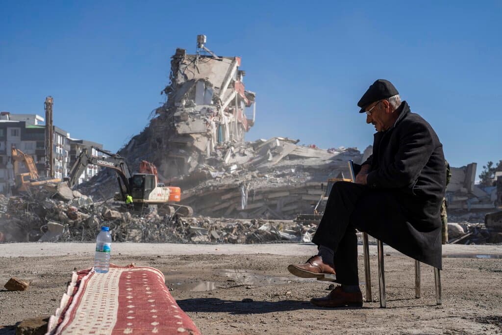 Mehmet Nasir Duran, sentado en una silla, contempla cómo maquinarias pesadas terminan de destruir el edificio en donde cinco de sus familiares quedaron atrapados.