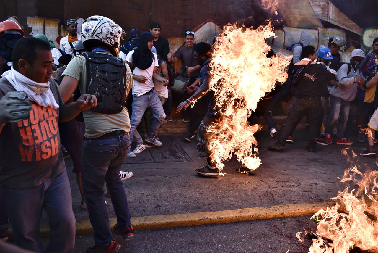 "When I approached and got through the circle of people around him to take photos, someone had already poured gasoline and set it on fire," said the Venezuelan photographer.