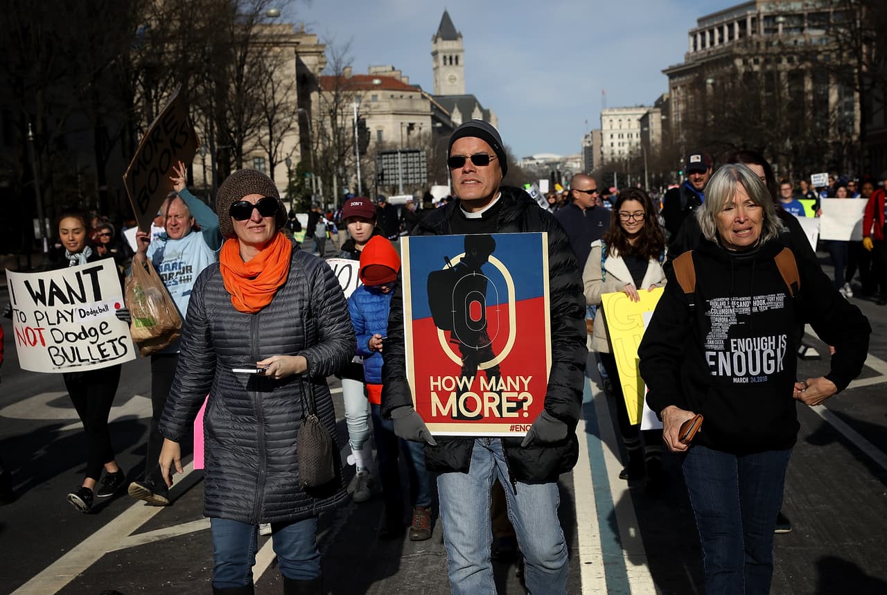 Adultos y jóvenes marchando juntos contra las armas en las calles de la capital. 
<br>