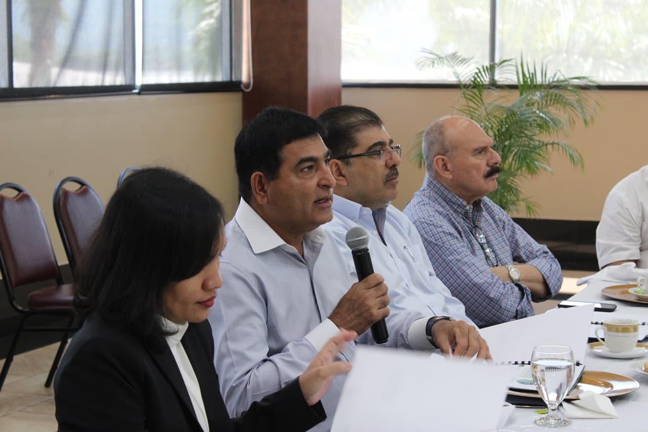 Mohammad Yusuf Amdani, dueño de Grupo Karim, sostiene el micrófono mientras habla en un desayuno de negocios de su compañía