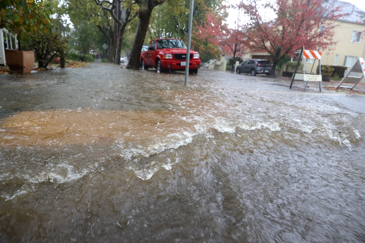 SAN RAFAEL, CALIFORNIA - OCTOBER 24: Water flows down a street on October 24, 2021 in San Rafael, California. A category 5 atmospheric river is bringing heavy precipitation, high winds and power outages to the San Francisco Bay Area. The storm is expected to bring anywhere between 2 to 5 inches of rain to many parts of the area. (Photo by Justin Sullivan/Getty Images)