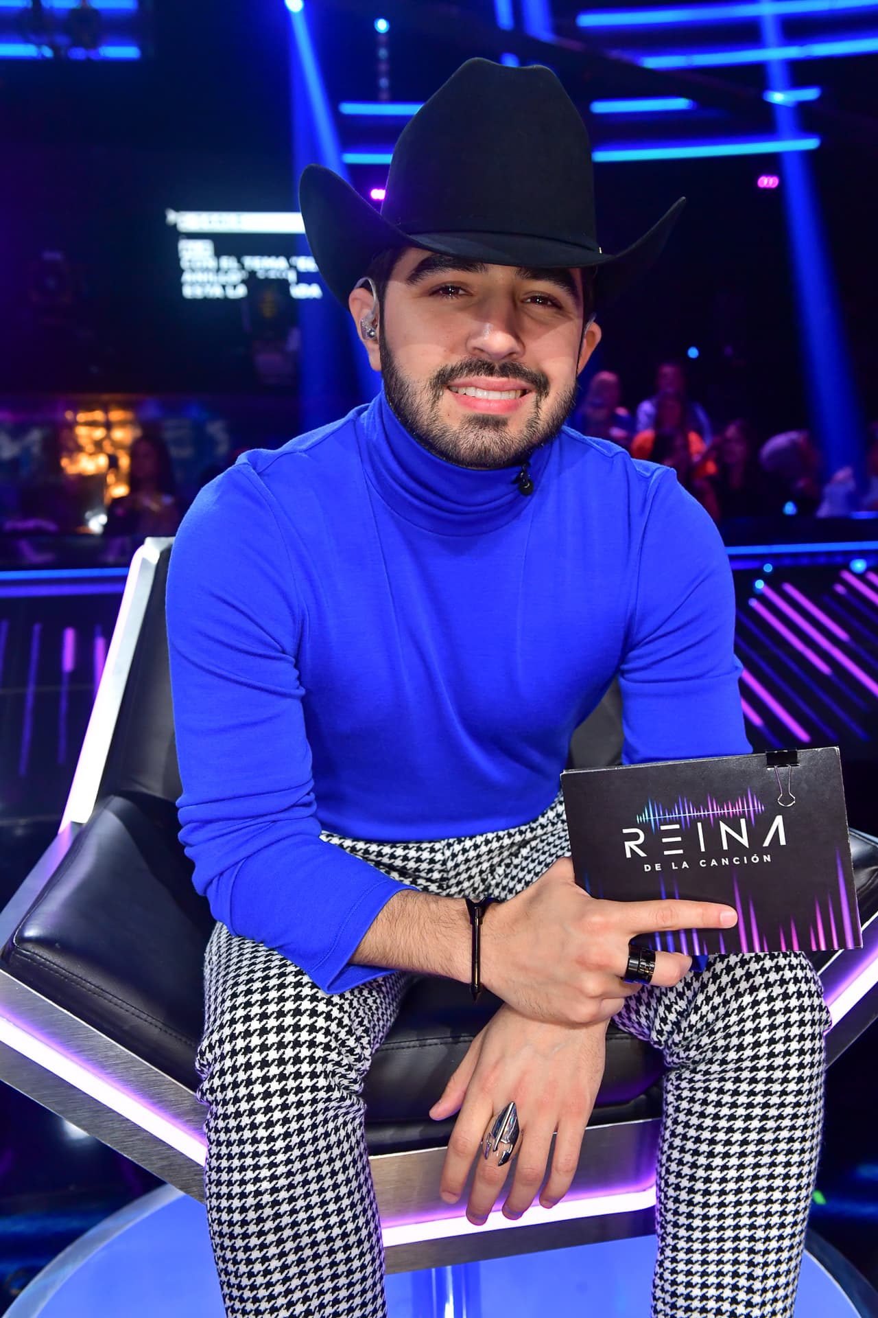 Sin chaqueta pero con sombrero Presidente, botas Tom Ford y accesorios de The Astorga Project, Joss se sentó al lado de sus compañeras con un look tipo londinense.