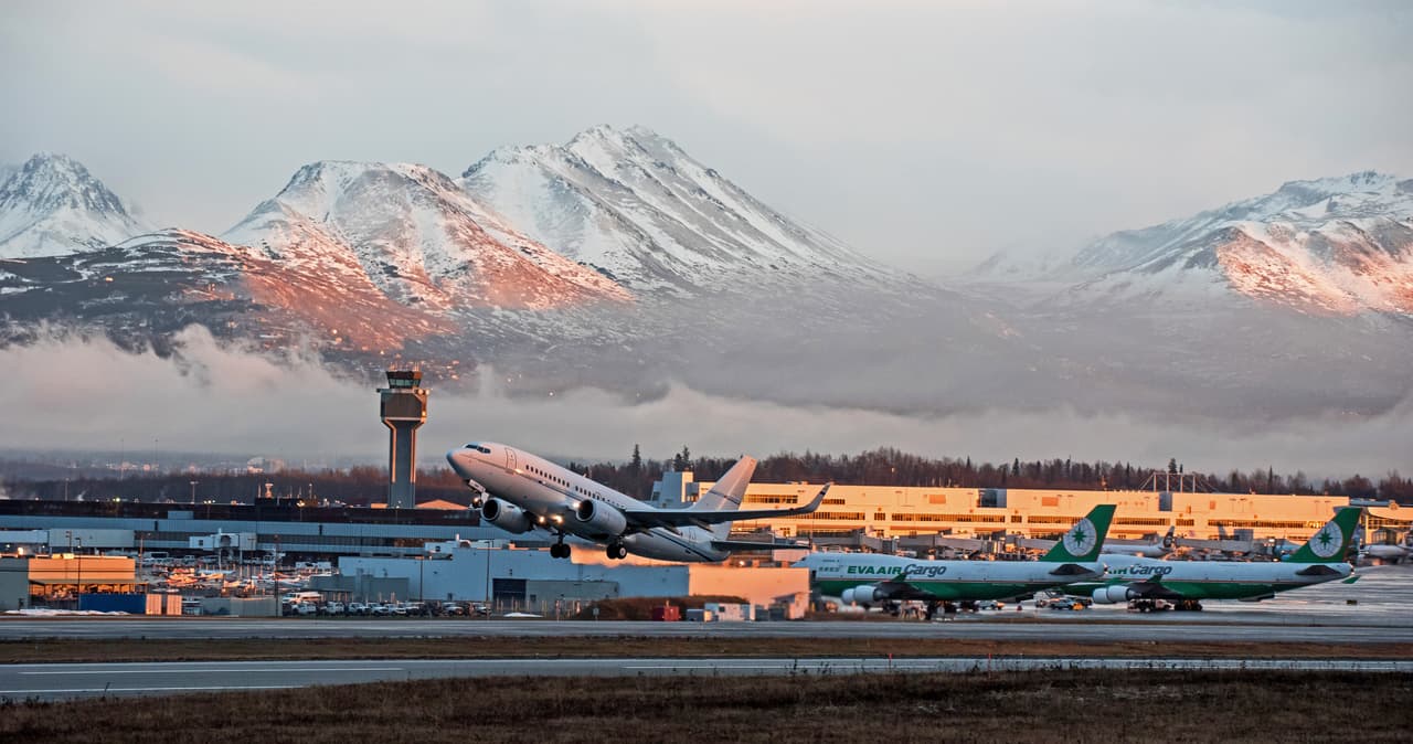 Anchorage, Alaska, USA - November 26, 2015: Aircraft depart from Ted Stevens Anchorage International Airport at sunset
