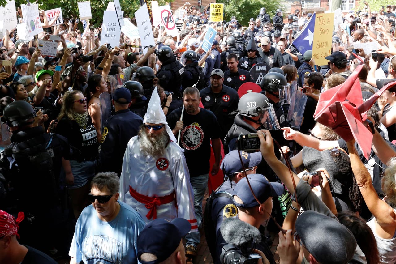 Police escorted KKK members through the crowds.