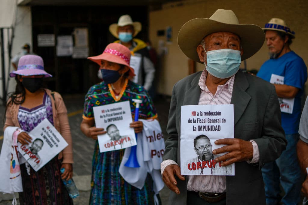People take part in a protest against Guatemalan Attorney General Consuelo Porras, who is seeking re-election, in Guatemala City, on April 6, 2022.