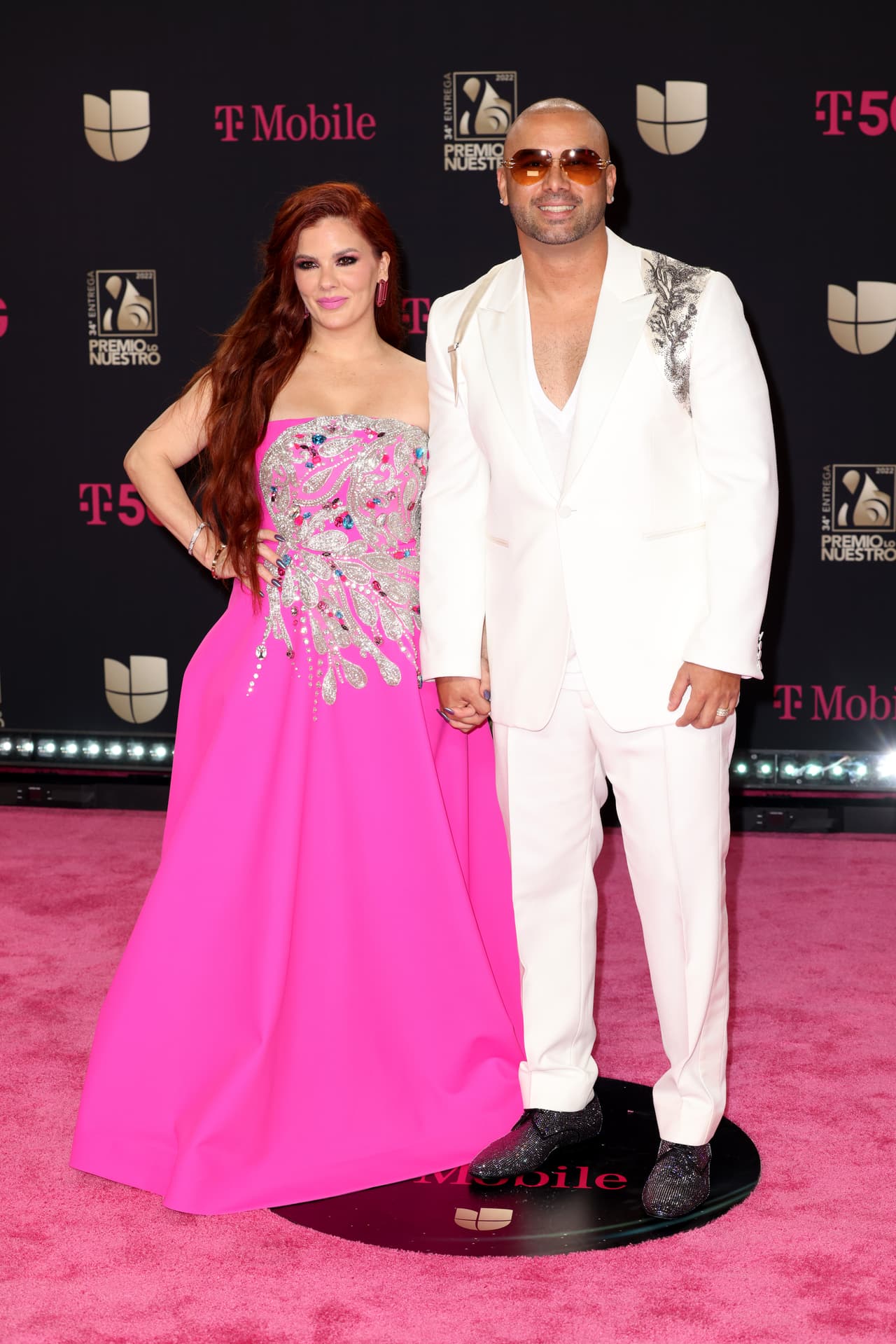 <b>Wisin y Yomaira Ortiz </b>
<br>Con un vestido fucsia, la esposa de Wisin (Yomaira Ortiz) se robó la mirada de los reflectores. Por su parte, el intérprete de ‘Escápate conmigo’ usó un traje blanco que tenía algunos detalles bordados en los hombros.
