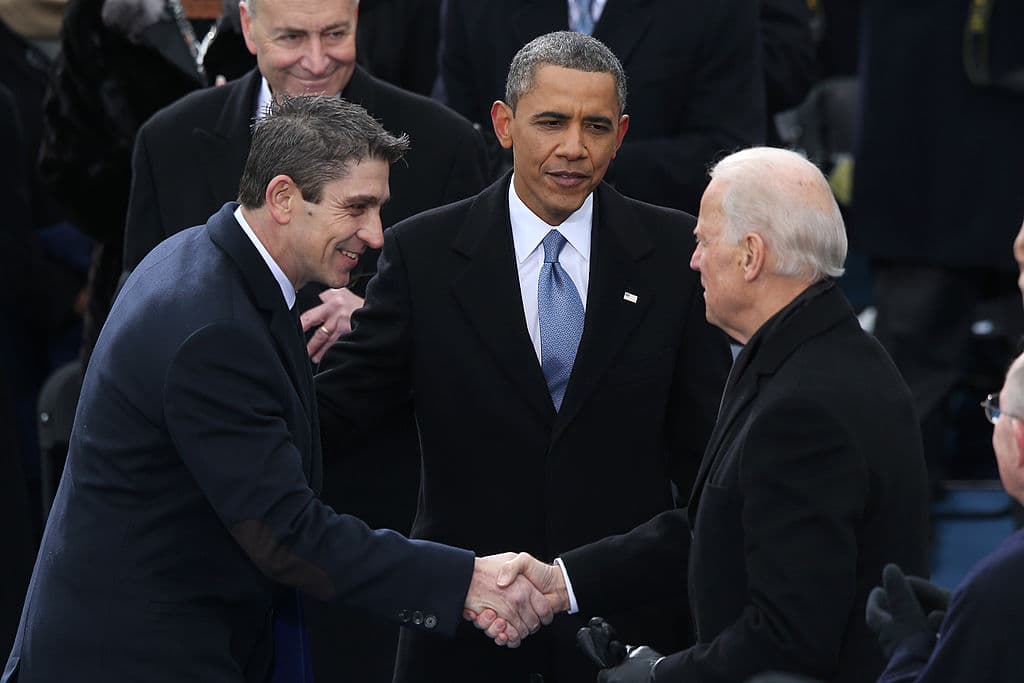 Poet Richard Blanco (L) is greeted by U.S. Vice President Joe Biden (R) and U.S. President Barack Obama after reciting his poem during the presidential inauguration on the West Front of the U.S. Capitol January 21, 2013 in Washington, DC.