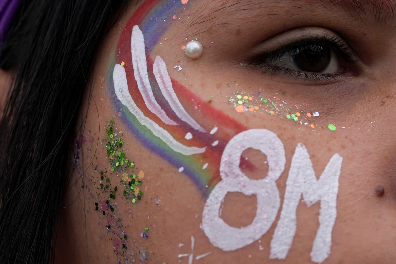A woman, her face painted with 8M referring to March 8th, takes part in an International Women's Day march in Buenos Aires, Argentina, Saturday, March 8, 2025. (AP Photo/Natacha Pisarenko)