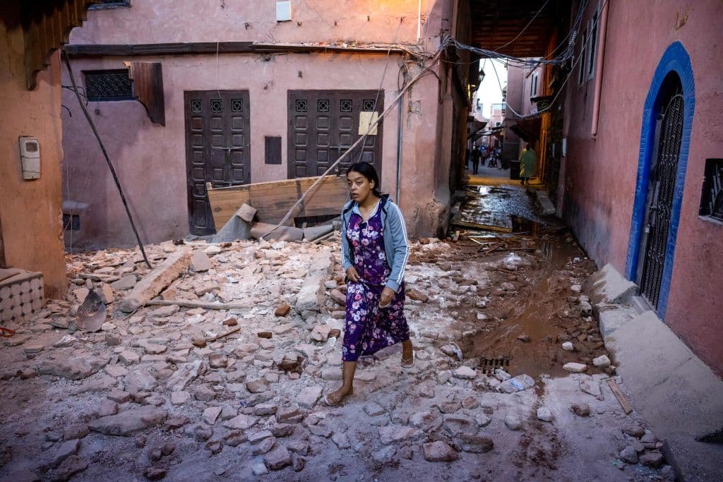 Una mujer camina entre los escombros de casas y edificios dañados por el terremoto en la medina de Marrakech.
