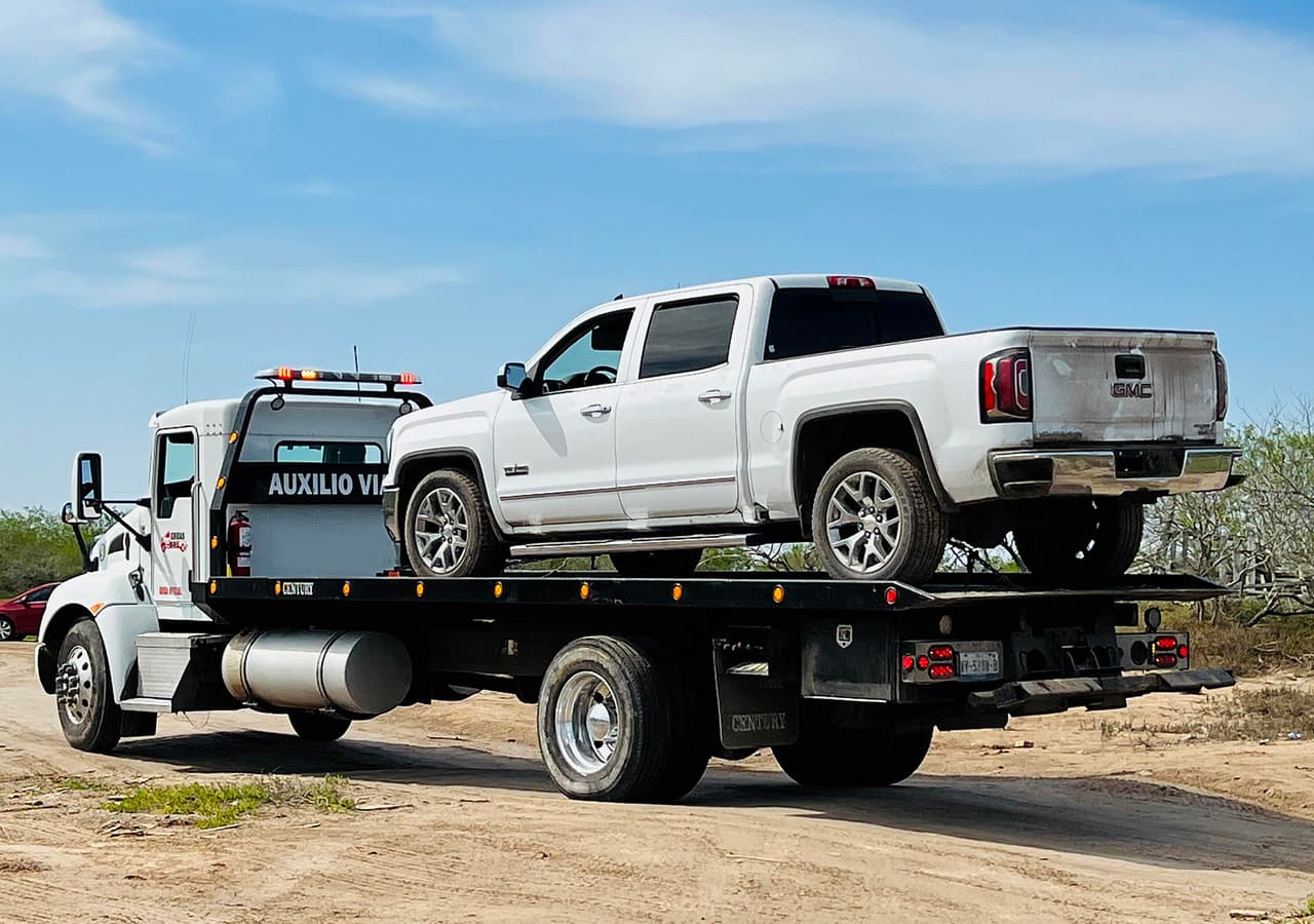 Personal de la Fiscalía General de Justicia trasladan un vehículo utilizado en el secuestro de cuatro ciudadanos estadounidenses.