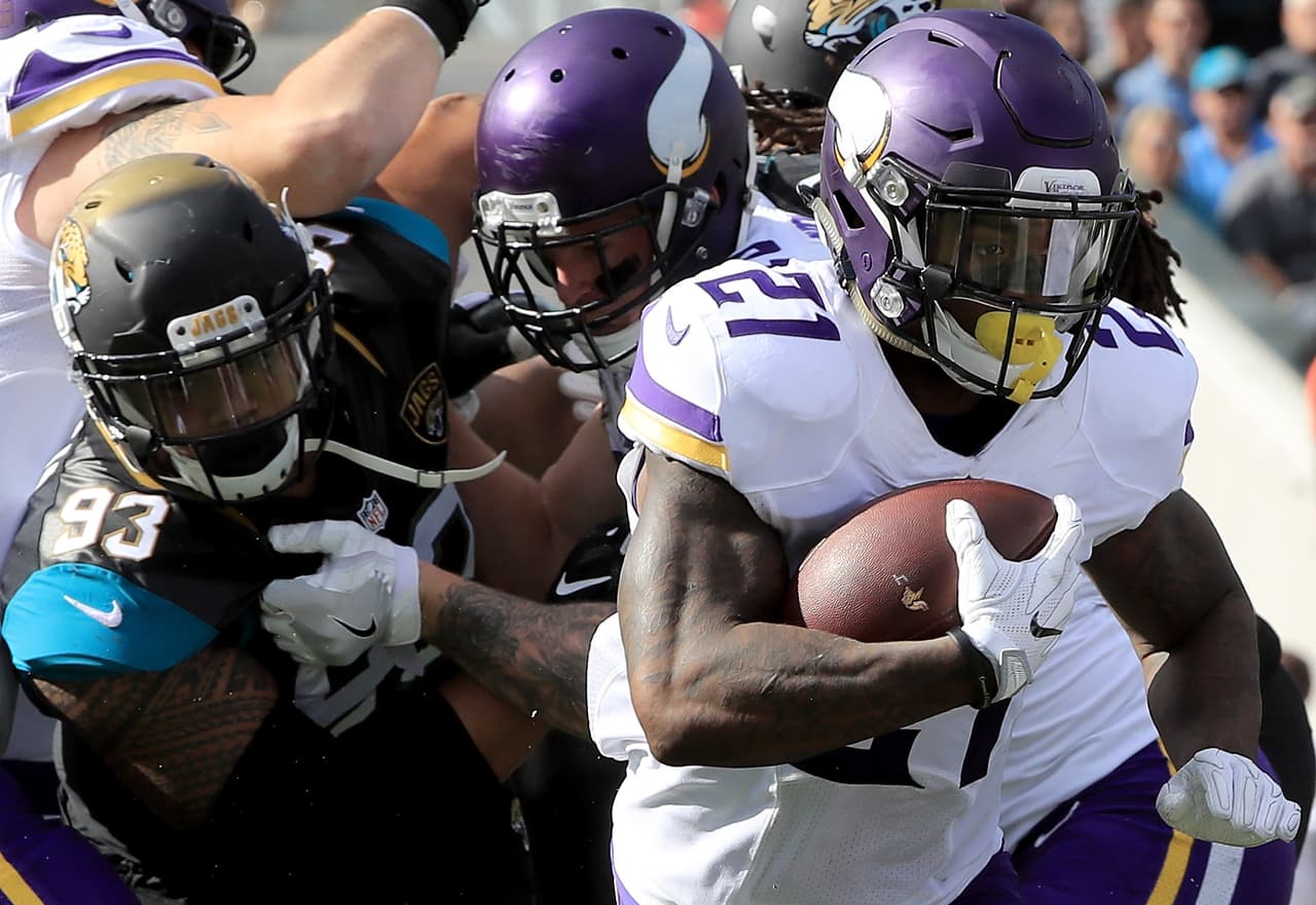 JACKSONVILLE, FL - DECEMBER 11: Jerick McKinnon #21 of the Minnesota Vikings runs for yardage as Tyson Alualu #93 of the Jacksonville Jaguars pursues during the game at EverBank Field on December 11, 2016 in Jacksonville, Florida. (Photo by Sam Greenwood/Getty Images)