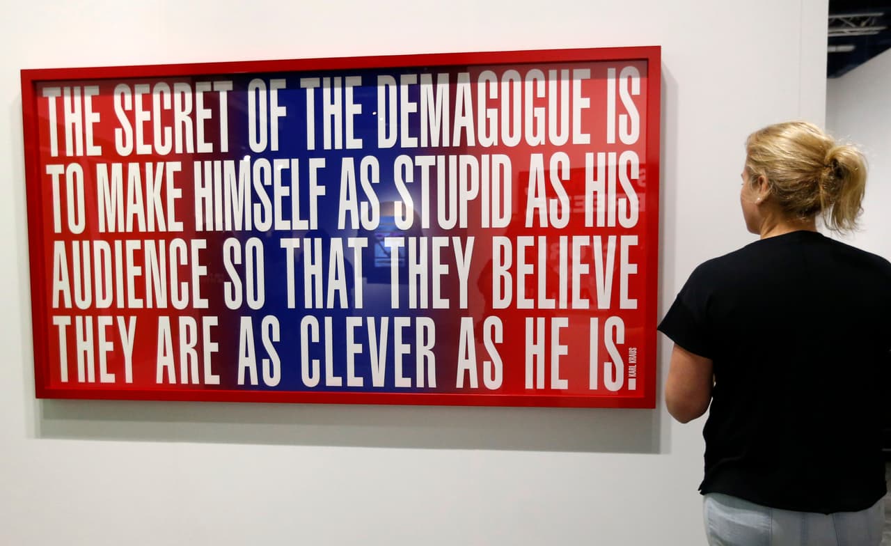 An art patron looks at "Untitled" by Barbara Kruger during Art Basel in Miami on November 30, 2016. Art Basel represents over 250 art galleries at the Miami Beach Convention Center and is considered one of the world's largest art festivals with art events throughout the city. / AFP / RHONA WISE / RESTRICTED TO EDITORIAL USE - MANDATORY MENTION OF THE ARTIST UPON PUBLICATION - TO ILLUSTRATE THE EVENT AS SPECIFIED IN THE CAPTION (Photo credit should read RHONA WISE/AFP/Getty Images)