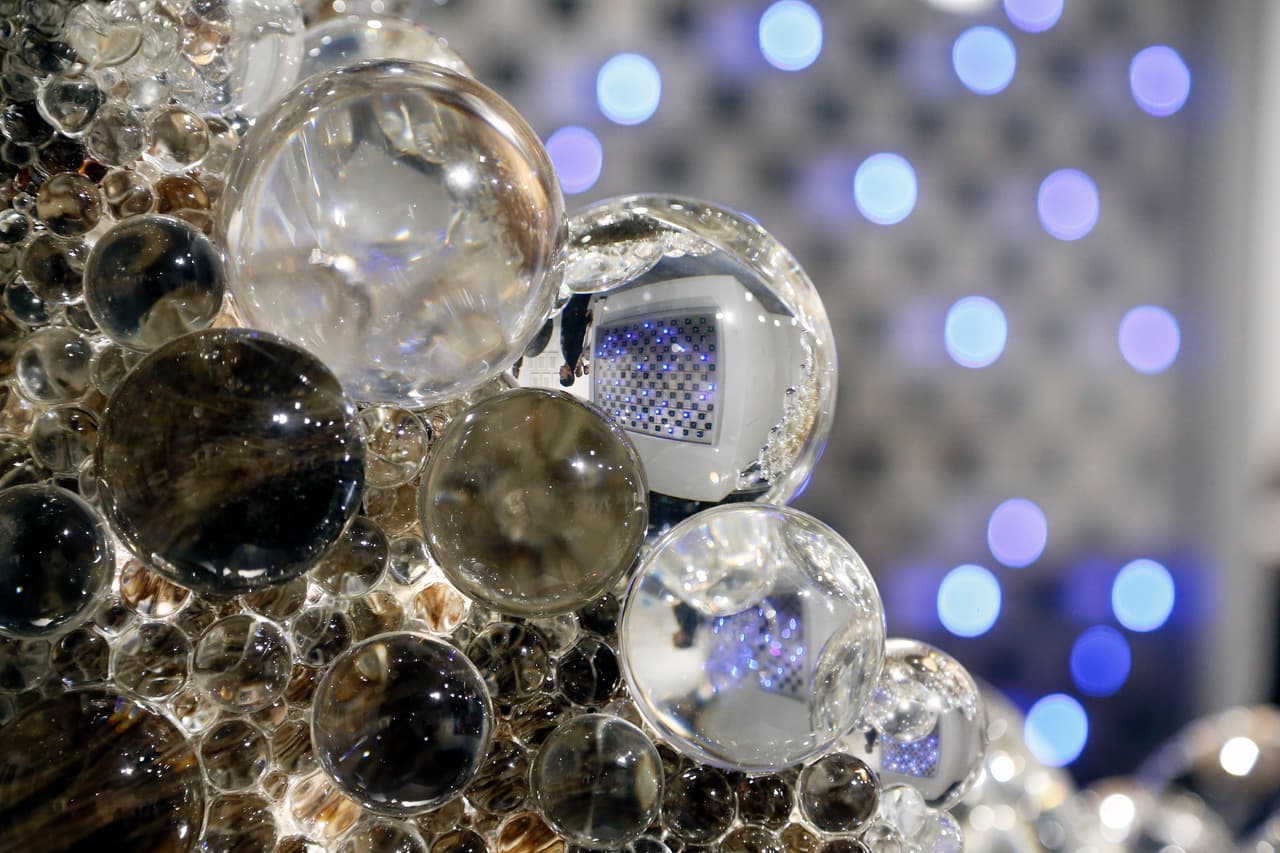 "Life" by Tatsuo is reflected in 'PixCell-Deer#44' by Kohei Nawa during Art Basel in Miami on November 30, 2016. Art Basel represents over 250 art galleries at the Miami Beach Convention Center and is considered one of the world's largest art festivals with art events throughout the city. / AFP / RHONA WISE / RESTRICTED TO EDITORIAL USE - MANDATORY MENTION OF THE ARTIST UPON PUBLICATION - TO ILLUSTRATE THE EVENT AS SPECIFIED IN THE CAPTION (Photo credit should read RHONA WISE/AFP/Getty Images)