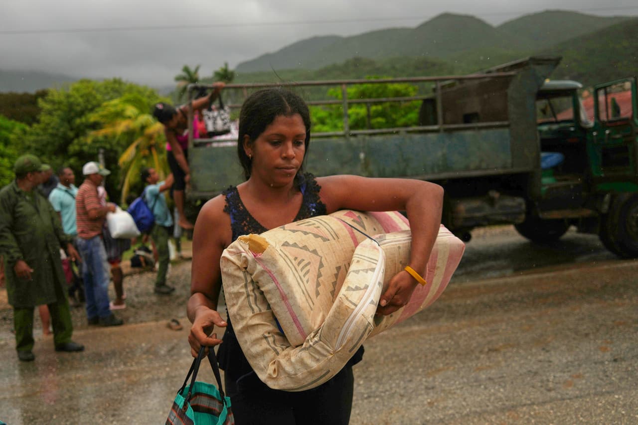 <b>Cuba</b>
<br>
<br>Una mujer que carga un colchón bajo la lluvia evacua antes de la llegada del huracán Melissa en Cañizo, una comunidad de Santiago de Cuba, el martes 28 de octubre de 2025.