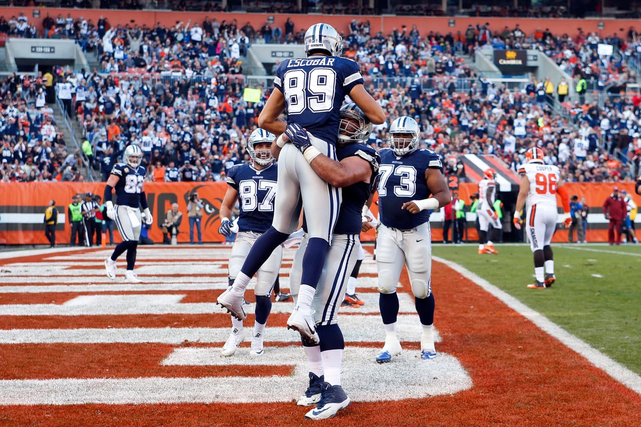 Dallas Cowboys tight end Gavin Escobar (89) celebrates his touchdown with center Travis Frederick in the second half of an NFL football game against the Cleveland Browns, Sunday, Nov. 6, 2016, in Cleveland. (AP Photo/Ron Schwane)