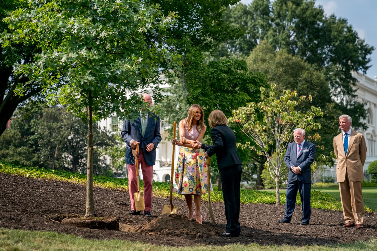 From left, President James Monroe's fifth generation grandson Richard Emory Gatchell, Jr., first lady Melania Trump, and President Dwight Eisenhower's granddaughter Mary Jean Eisenhower, White House Historical Association Vice Chairman John Rogers, and White House Historical Association Chairman Fred Ryan participating in a presidential tree planting ceremony on the South Lawn of the White House, Monday, Aug. 27, 2018, in Washington. The sapling was grown from the Eisenhower Oak and replaces a tree which blew down during a windstorm earlier this year. Additionally, this year marks the 200th anniversary of President Monroe's family moving back into the White House after the British set fire to it during the War of 1812. (AP Photo/Andrew Harnik)