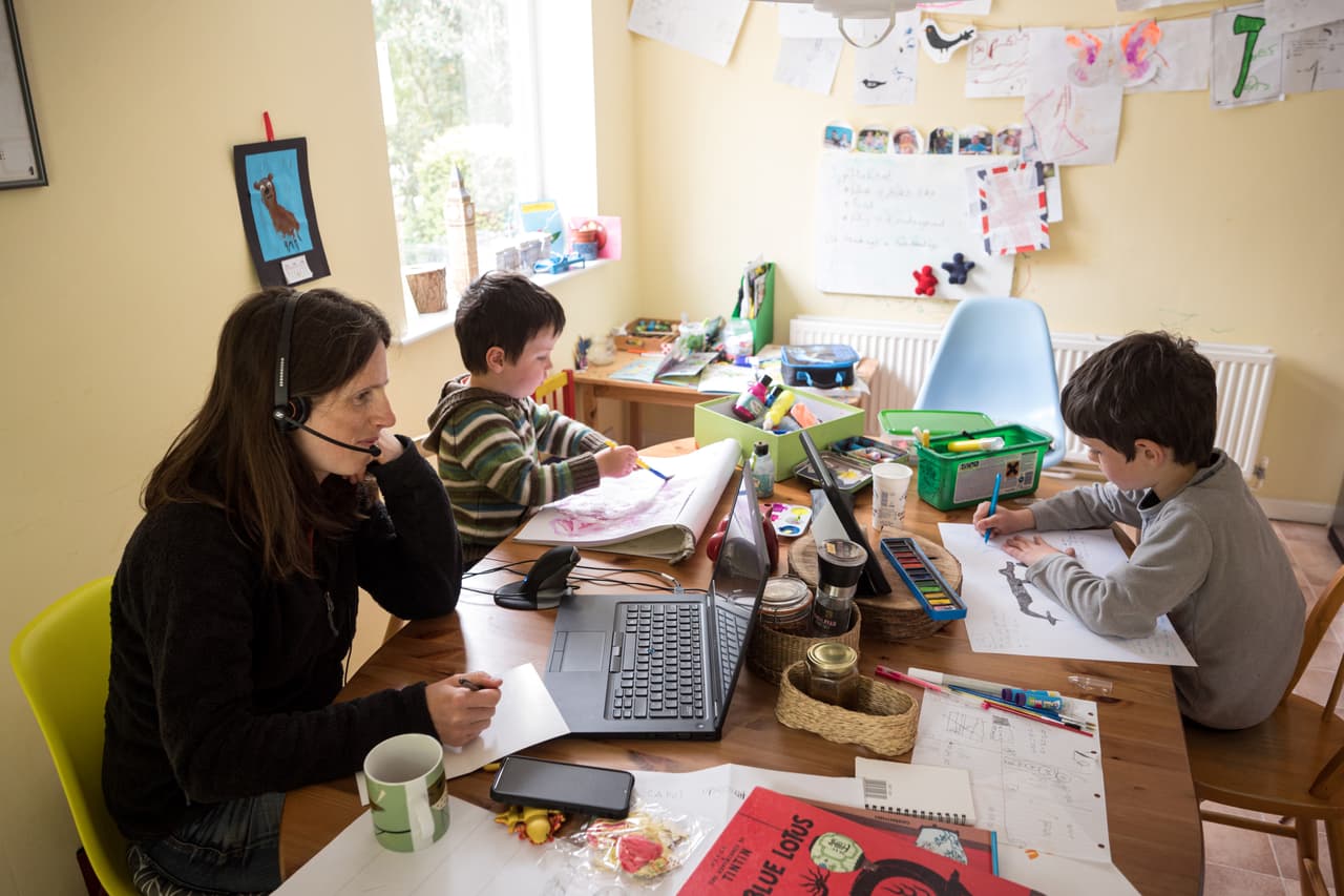 Six-year-old Leo (R) and his three-year old brother Espen (C) complete homeschooling activities suggested by the online learning website of their infant school, as his mother Moira, an employee of a regional council, works from home in the village of Marsden, near Huddersfield, northern England on May 15, 2020, during the novel coronavirus COVID-19 pandemic. Leo (R), aged 6, and Espen, aged 3, undertake homeschool activities suggested by the online learning website of their infant school whilst their mother Moira, a council employee, works from home in the village of Marsden, near Huddersfield, northern England on May 15, 2020. - Prime Minister Boris Johnson has urged millions unable to work from home to return to their jobs under the new guidelines, which do not apply in Scotland, Wales or Northern Ireland. (Photo by OLI SCARFF / AFP) (Photo by OLI SCARFF/AFP via Getty Images)