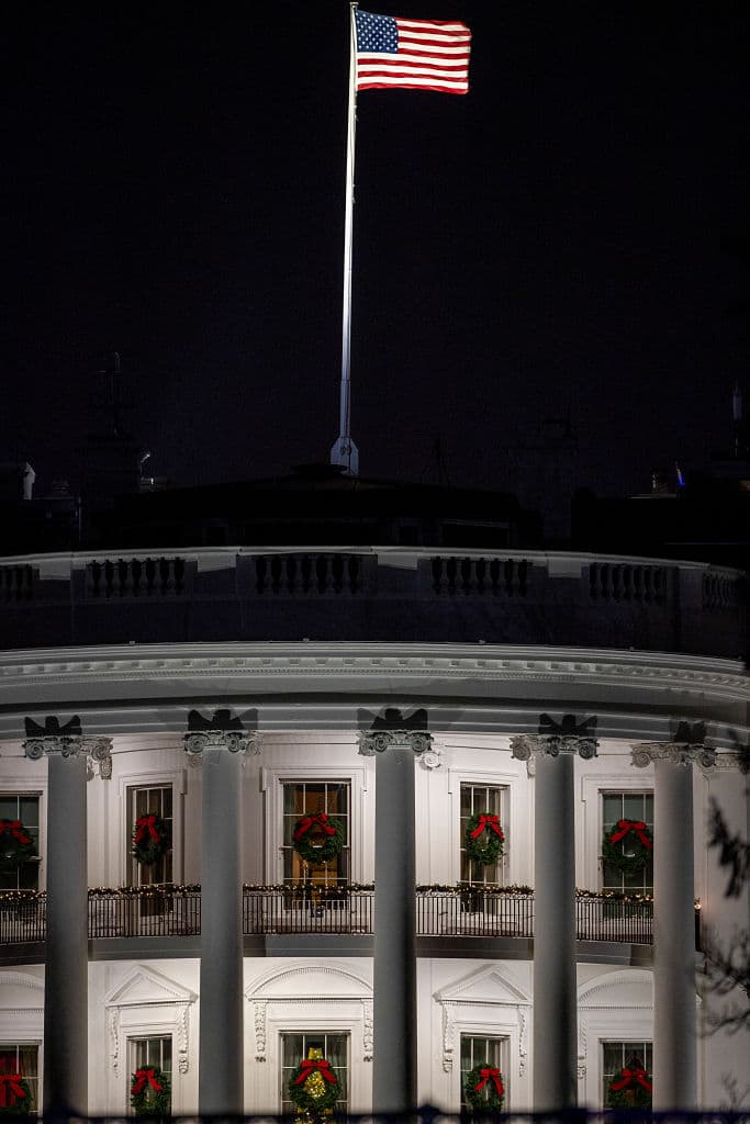 La Casa Blanca luce las coronas y adornos navideños de noche.