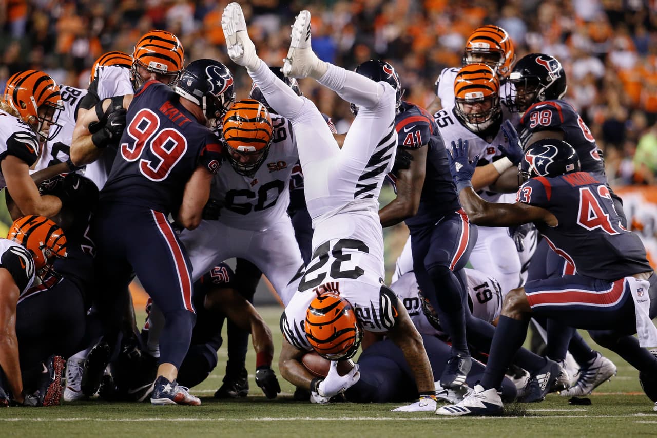 Cincinnati Bengals running back Jeremy Hill (32) lands after leaping over the scrum during the second half of an NFL football game against the Houston Texans, Thursday, Sept. 14, 2017, in Cincinnati. (AP Photo/Frank Victores)