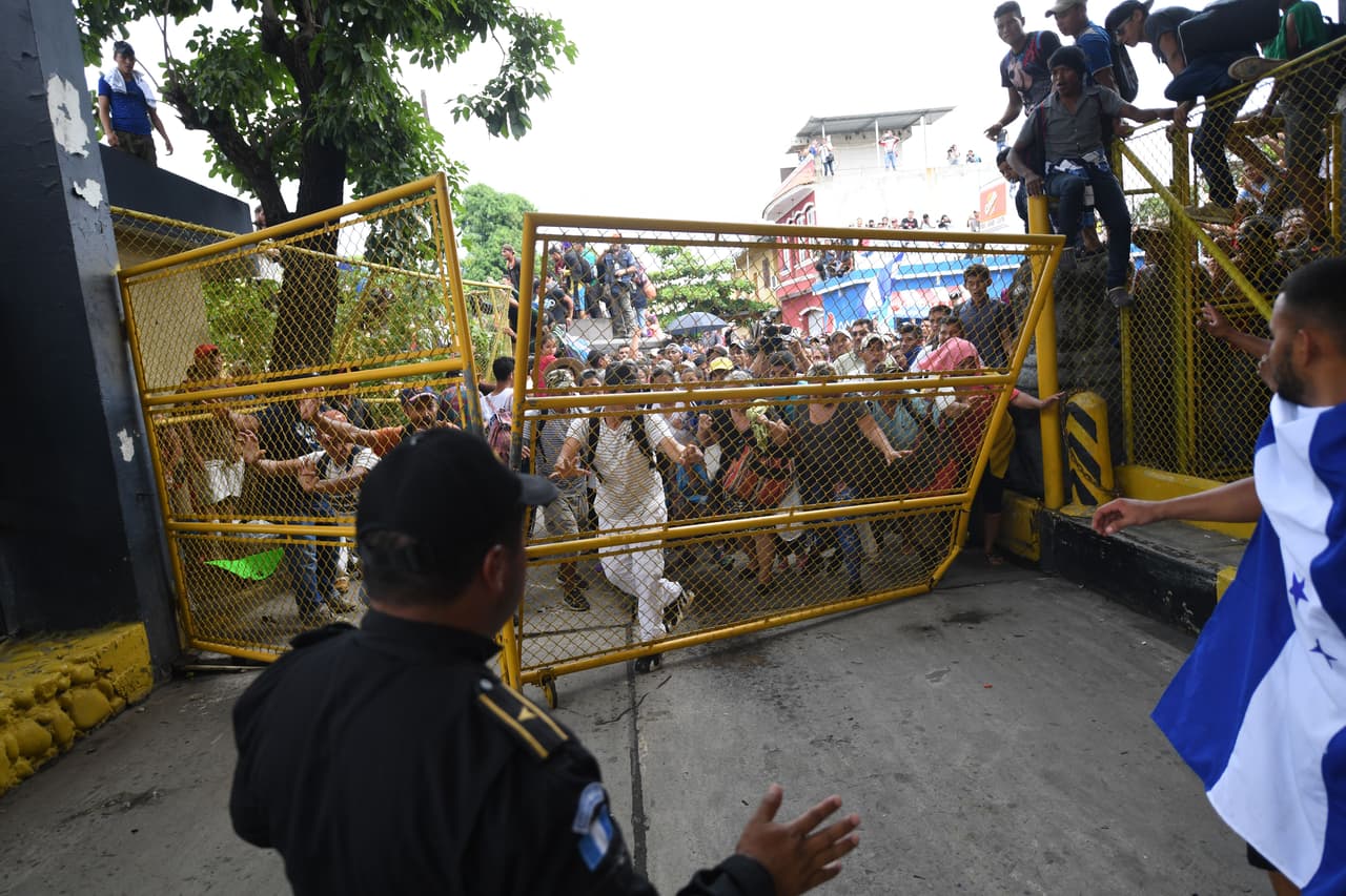 Aunque algunos pasaban escalando la barda, la multitud empujaba la puerta que los separaba del puente sobre el río Suchiate, la barrera natural fronteriza entre los dos países.