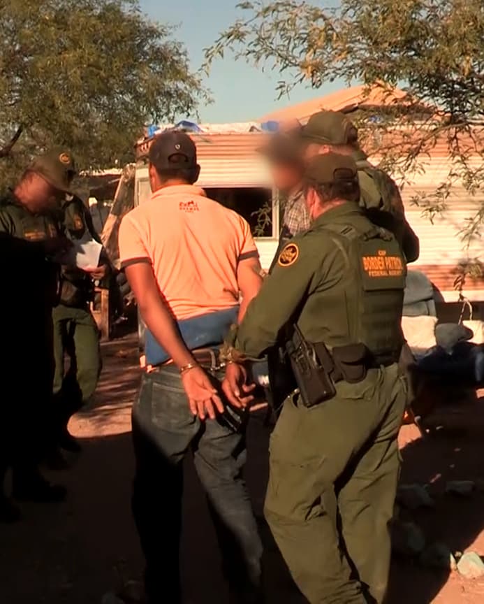 Un inmigrante es transportado a la patrulla.