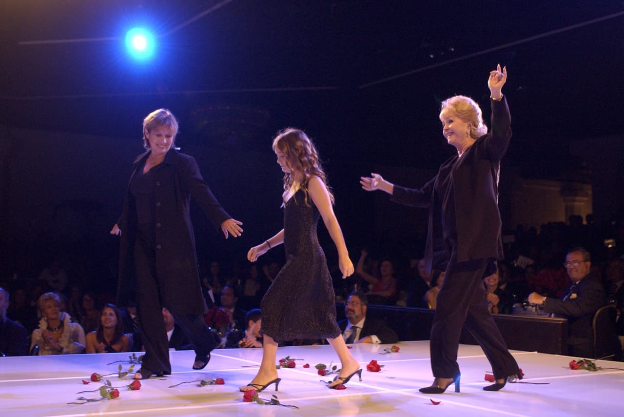 BEVERLY HILLS, CA - AUGUST 19: (NO NATIONAL MAGAZINE SALES) Actress Carrie Fischer with her daughter and mother, Debbie Reynolds, walks on stage during the 2nd Annual "Runway for Life" celebrity fashion show benefiting St. Jude Children's Research Hospital and celebrating the DVD release of the Academy Award winning film "Chicago" at the Beverly Hilton August 19, 2003 in Beverly Hills, California. (Photo by Vince Bucci/Getty Images)