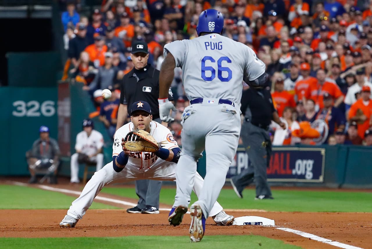 HOUSTON, TX - OCTOBER 29: Yasiel Puig #66 of the Los Angeles Dodgers is thrown out at first against Yuli Gurriel #10 of the Houston Astros in game five of the 2017 World Series at Minute Maid Park on October 29, 2017 in Houston, Texas. (Photo by Jamie Squire/Getty Images)
