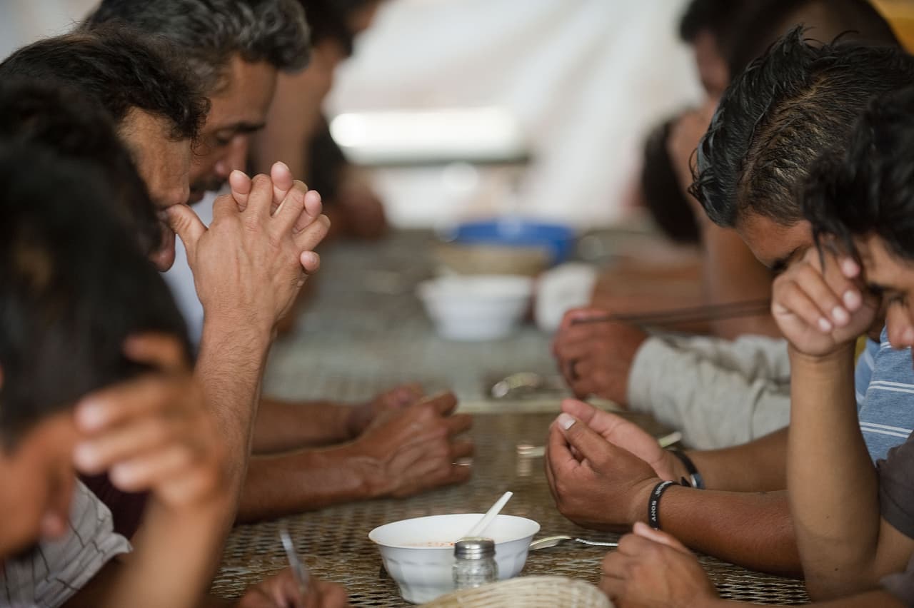 A group of illegal immigrans from Central America deported from the USA, are seen as they eat in a shelter near the Mexico-U.S. border, in Nogales, Sonora, Mexico, on July 28, 2010. A US federal judge blocked the most controversial parts of Arizona's new immigration law, barring police from checking the immigrant status of suspected criminals. AFP PHOTO/Alfredo Estrella (Photo credit should read ALFREDO ESTRELLA/AFP/Getty Images)