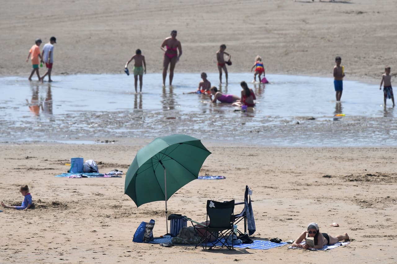 En Reino Unido algunos viajes en tren se suspendieron y las locomotoras tuvieron que reducir la velocidad para evitar que las vías se doblaran por el calor. En la fotografía un grupo de británicos que aprovecharon el calor para refrescarse en Camber Sandsal, al sur del país.