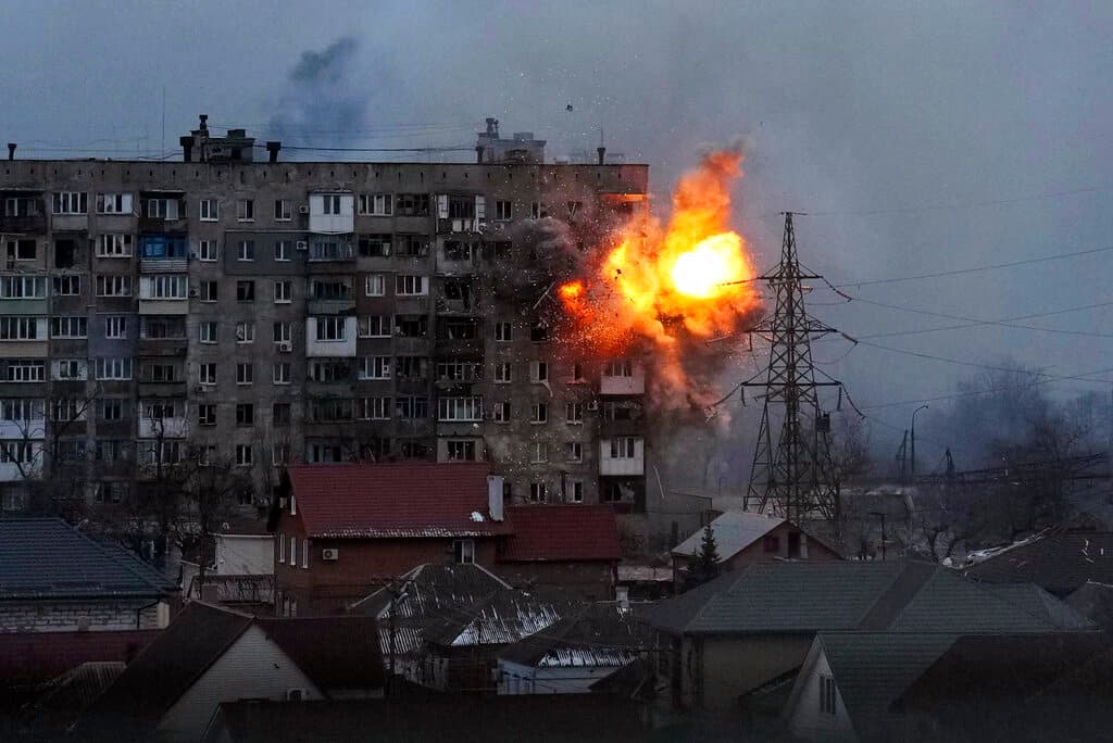 An apartment building explodes after a Russian army tank fires in Mariupol, Ukraine, Friday, March 11, 2022.