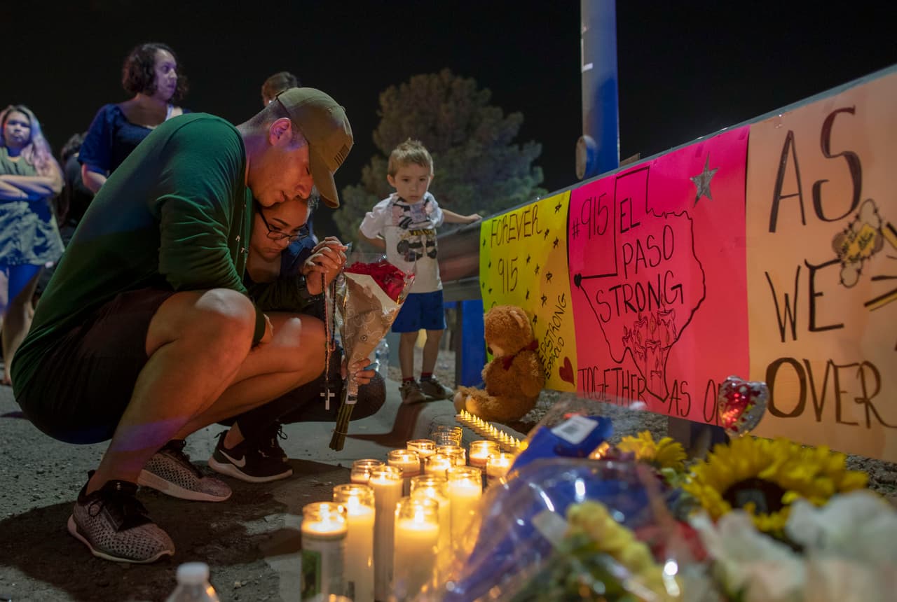 Rene Aguilar and Jackie Flores pray at a makeshift memorial for the victims of Saturday's mass shooting at a shopping complex in El Paso, Texas, August 4, 2019.