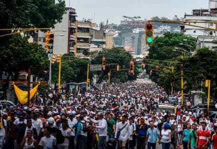 Thousands of demonstrators walked miles across Caracas to reach the Venezuelan Episcopal Conference April 22, where opponents gathered to protest against the government of Nicolás Maduro. (Juan Barreto / AFP / GettyImages)