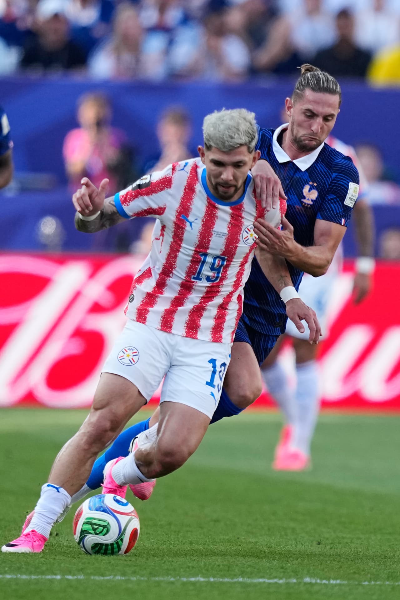 Adrien Rabiot agarra por el hombro al paraguayo Julio Enciso.