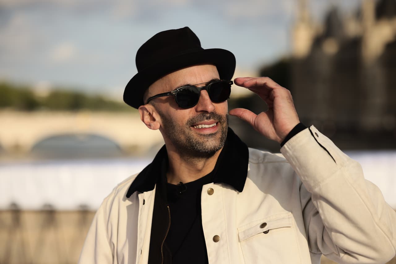 El artista callejero francés JR posa mientras prepara el inflado de su obra "La cueva del Pont Neuf" en el puente Pont Neuf, el miércoles 20 de mayo de 2026, en París, antes de su inauguración gratuita para el público del 6 al 28 de junio. (Foto AP/Thomas Padilla)