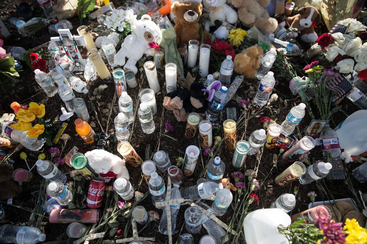 Al pie de un árbol en el estacionamiento del Walmart, los vecinos y visitantes han colocado flores, botellas de agua, velas, osos de peluche, carros de juguete e incluso comida en un gesto simbólico con los 10 inmigrantes indocumentados que murieron asfixiados en el trayecto de Laredo a San Antonio, en Texas.