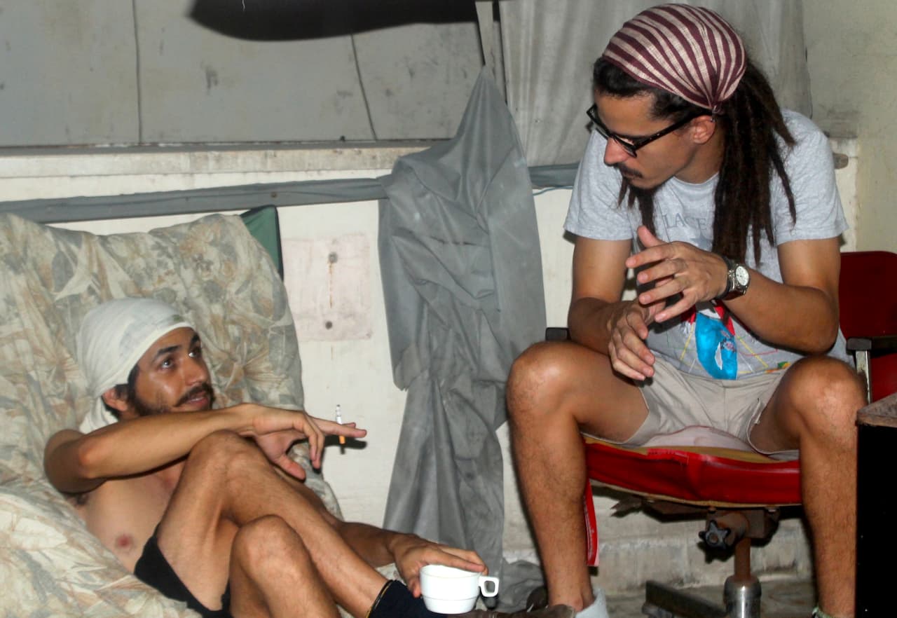 Jorgito and and his friend Rosman chat at Jorgito's Havana apartment.