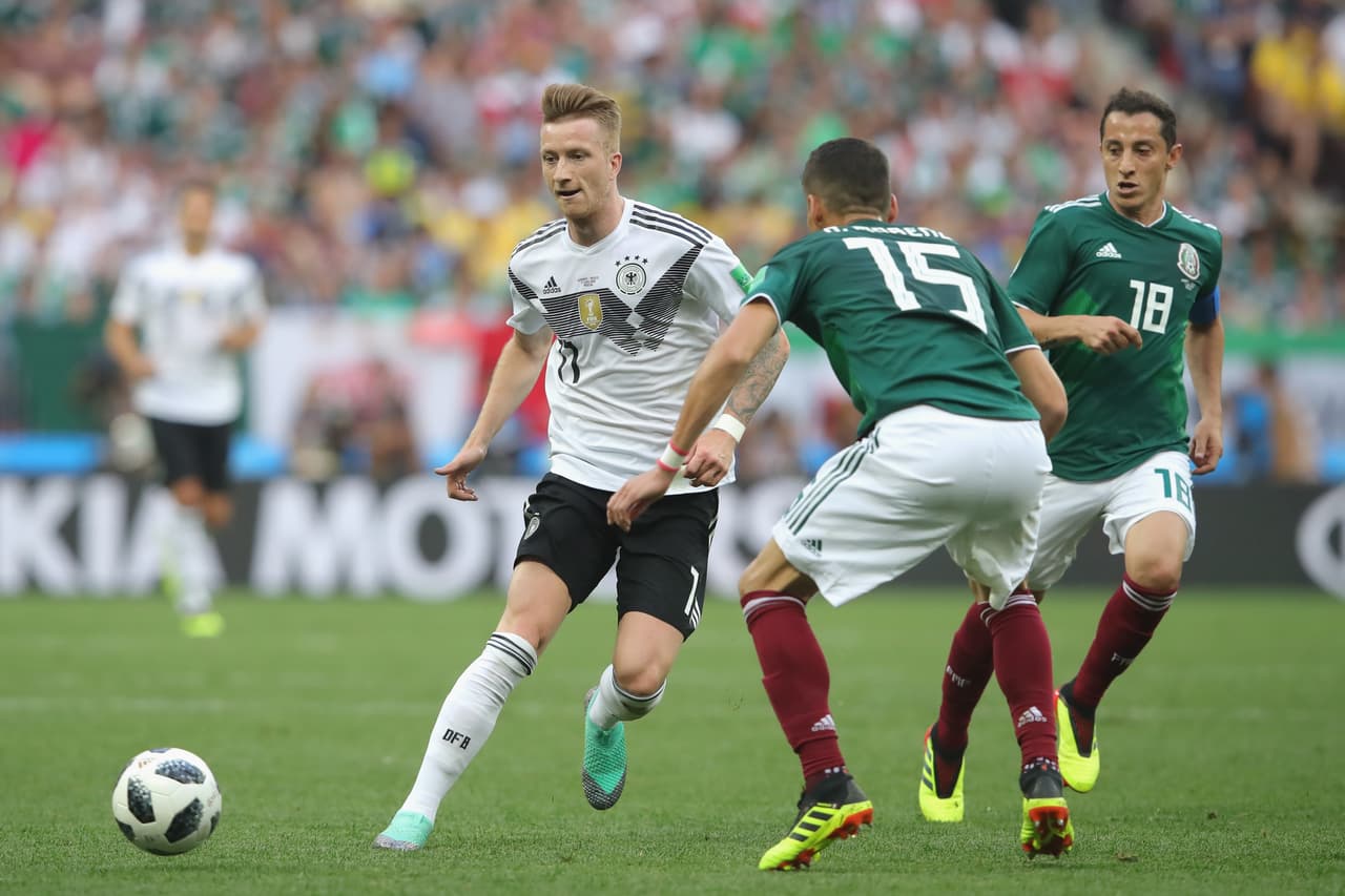 MOSCOW, RUSSIA - JUNE 17: Marco Reus of Germany battles for the ball with Hector Moreno of Mexico during the 2018 FIFA World Cup Russia group F match between Germany and Mexico at Luzhniki Stadium on June 17, 2018 in Moscow, Russia. (Photo by Alexander Hassenstein/Getty Images)