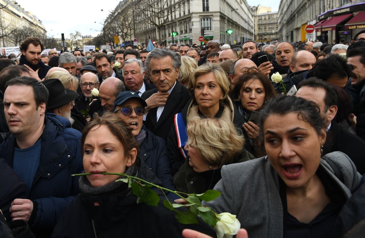 French philosopher Bernard-Henri Levy (C) and Ile De France Region President Valerie Pecresse (C/R) walk with others during a silent march in Paris on March 28, 2018, in memory of Mireille Knoll, an 85-year-old Jewish woman murdered in her home in what police believe was an anti-Semitic attack. The partly burned body of Mireille Knoll, who escaped the mass deportation of Jews from Paris during World War II, was found in her small apartment in the east of the city on March 23, by firefighters called to extinguish a blaze. / AFP PHOTO / ALAIN JOCARD (Photo credit should read ALAIN JOCARD/AFP/Getty Images)