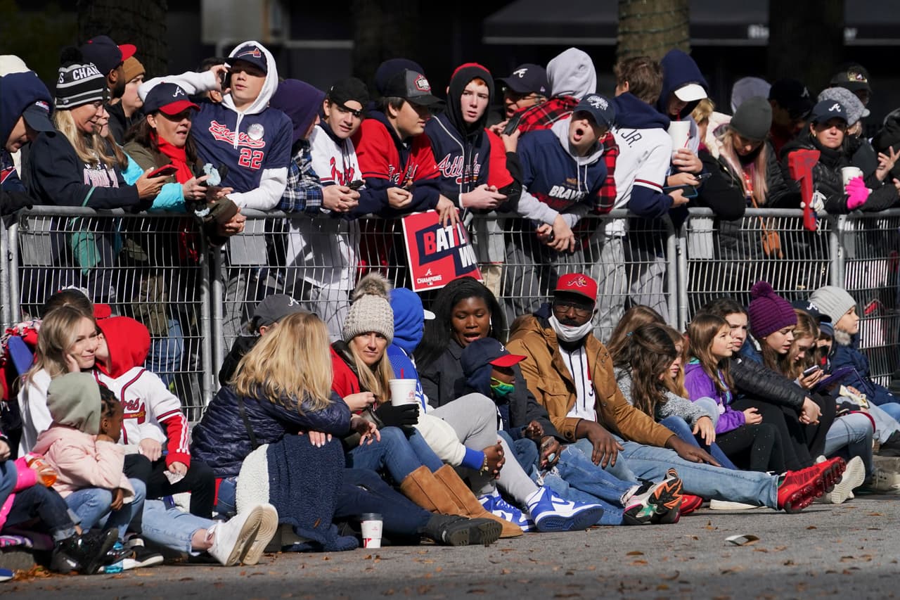 Baseball fans wait for the Atlanta Braves before their victory parade, Friday, Nov. 5, 2021, in Atlanta. The Braves beat the Houston Astros 7-0 in Game 6 on Tuesday to win their first World Series baseball title in 26 years. (AP Photo/Brynn Anderson)