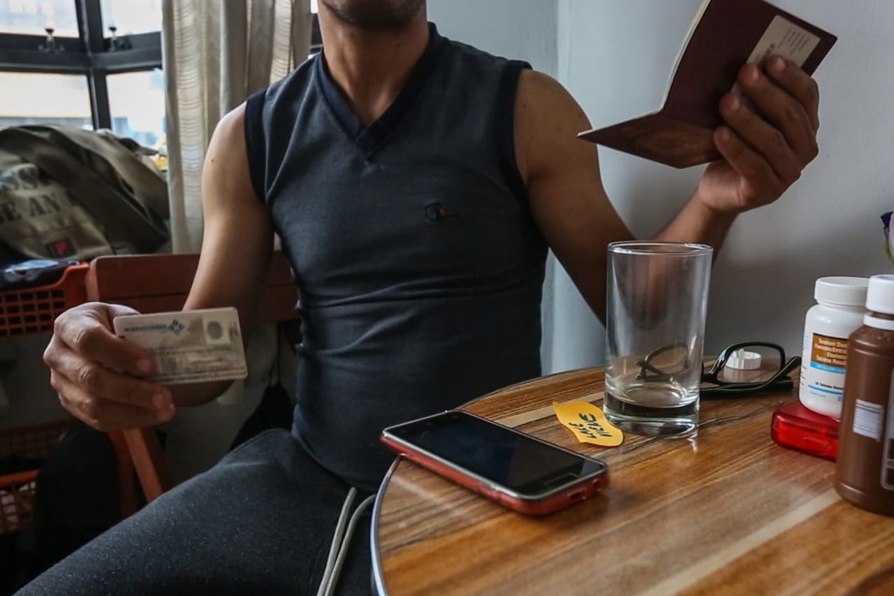 Alfonso muestra su pasaporte venezolano y su carnet de extranjería. El migrante lamenta que ingresar al sistema público de salud es complicado: "Se necesita tramitar el carnet de extranjería como persona en condición vulnerable. Eso implica dinero y sacarse un informe médico que también cuesta”.
<br>