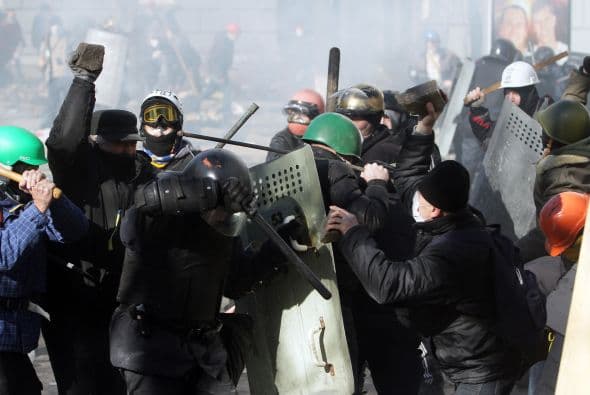La policía ucraniana cercó hoy a los manifestantes en el corazón de las protestas opositoras de la plaza de la Independencia de Kiev (Maidán), tras una jornada en la que murieron 14 personas en los disturbios que estallaron en la capital. Víktor "Yanukóvich se ha convertido en un presidente sangriento", aseguró hoy el dirigente opositor Vitali Klitschkó en un llamamiento a los países democráticos para que intervengan en Ucrania y frenen la violenta confrontación. Según se acercaba la medianoche, los temidos Berkut, el destacamento antidisturbios, estrechaban el cerco en torno a los miles de manifestantes concentrados en el Euromaidán, bastión de las protestas desde el pasado 21 de noviembre. "Los extremistas de la oposición han cruzado la línea roja; matan a inocentes en la calles de la capital de Ucrania, vejan a mujeres, queman edificios y automóviles. Y si los disturbios continúan, nos veremos obligados a actuar con firmeza", rezaba el ultimátum del Servicio de Seguridad y el Ministerio del Interior de Ucrania. Advierten a los americanos que se queden dentro de las casas y de nuevo se sienten explosiones en la ciudad.
